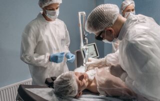 2 medical practitioners doing injections on a patient at a medspa