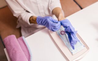 med spa nurse putting blue gloves on